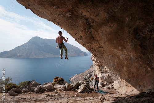 Climber hanging on the rope on overhanging wall. Kalymnos island, Greece.