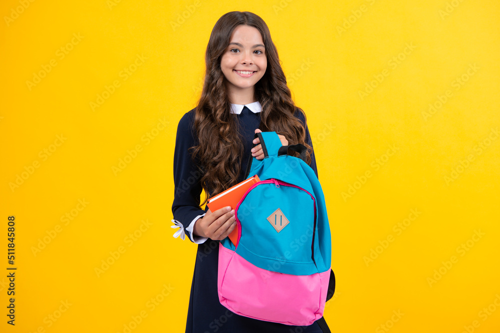 Schoolchild, teenage student girl hold book on yellow isolated studio background. School and education concept. Back to school. Schoolchild, teenage student girl hold book on yellow isolated studio background. School and education concept. Back to school.