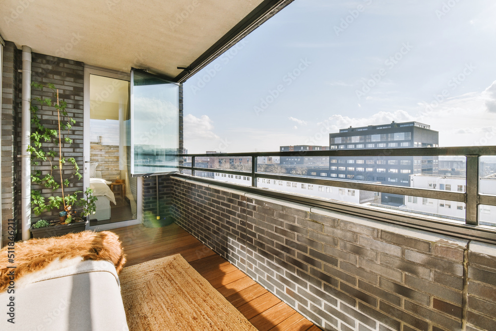 A balcony of a house with glass walls and stylish furniture - obrazy, fototapety, plakaty 
