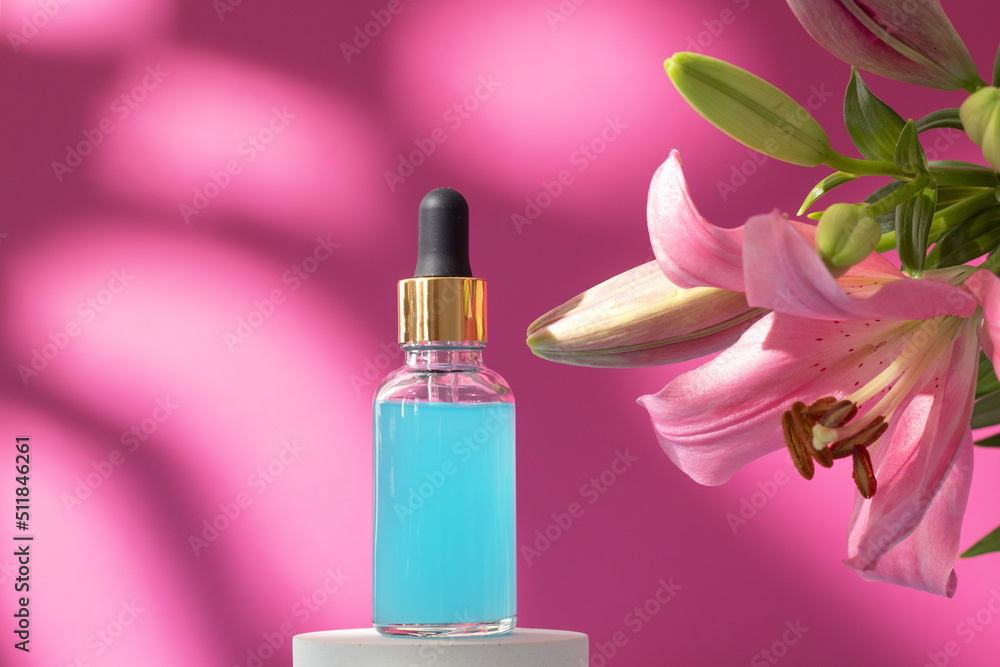 Cosmetic bottle on podium with lily flower and shadow on pink background. Face and body care spa concept. Hyaluronic acid oil, serum with collagen and peptides skin care product Cosmetic bottle on podium with lily flower and shadow on pink background. Face and body care spa concept. Hyaluronic acid oil, serum with collagen and peptides skin care product