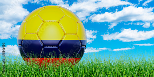 Soccer ball with Colombian flag on the green grass against blue sky  3D rendering