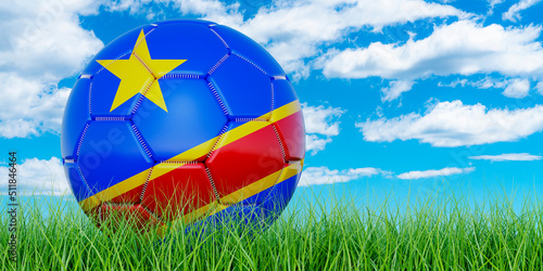 Soccer ball with Congolese Democratic Republic flag on the green grass against blue sky, 3D rendering