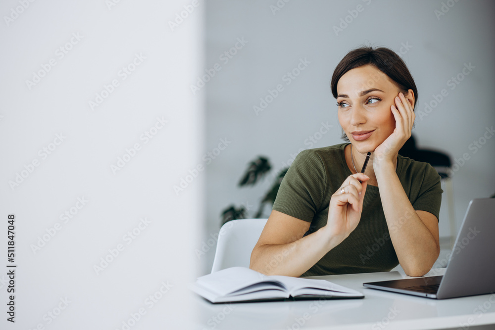 Young woman working on laptop at home Young woman working on laptop at home