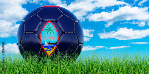 Soccer ball with Guamanian flag on the green grass against blue sky  3D rendering