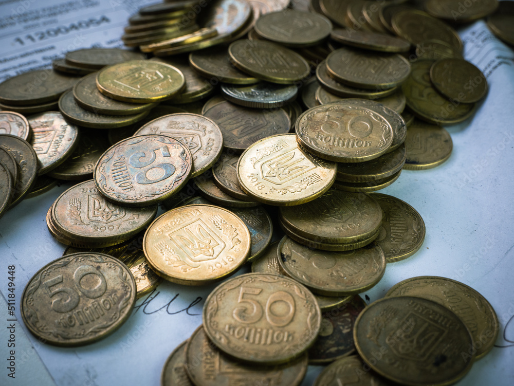 Ukrainian coins lie in a pile on documents Ukrainian coins lie in a pile on documents
