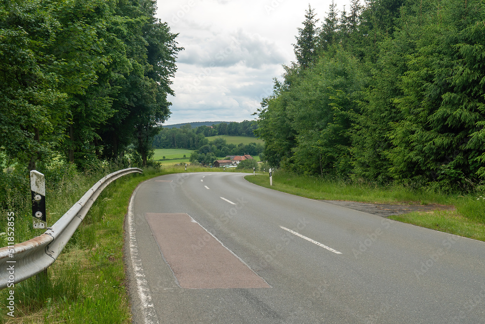 Fototapeta premium Asphalt road leading to the village. Bavaria, Germany.