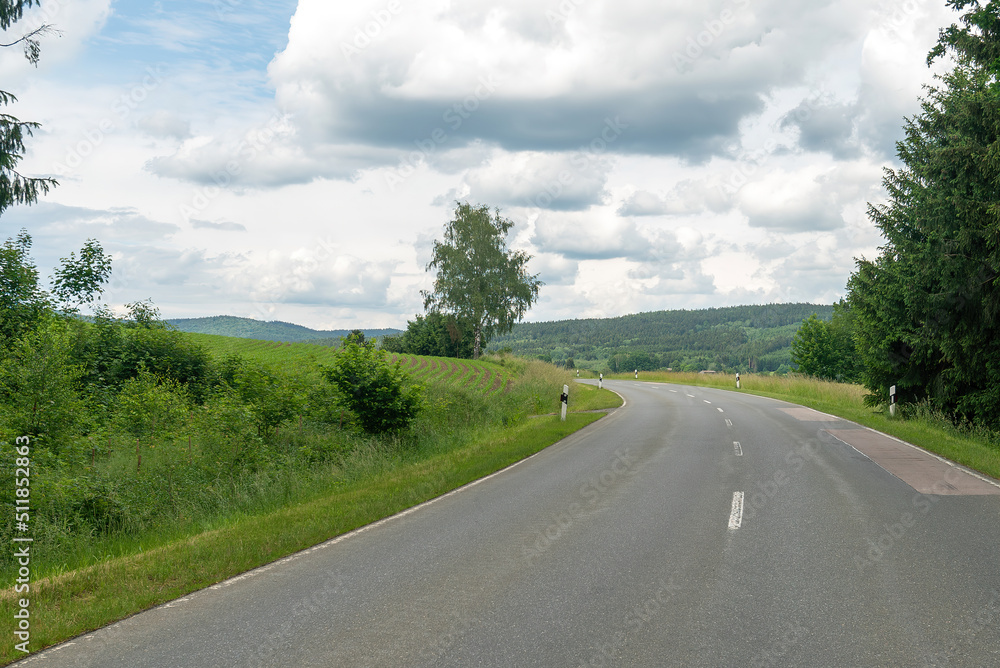 Asphalt road leading to the village. Bavaria, Germany. Asphalt road leading to the village. Bavaria, Germany.