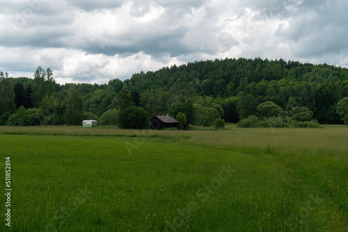 Mountains And Old Wooden Barn In The Field