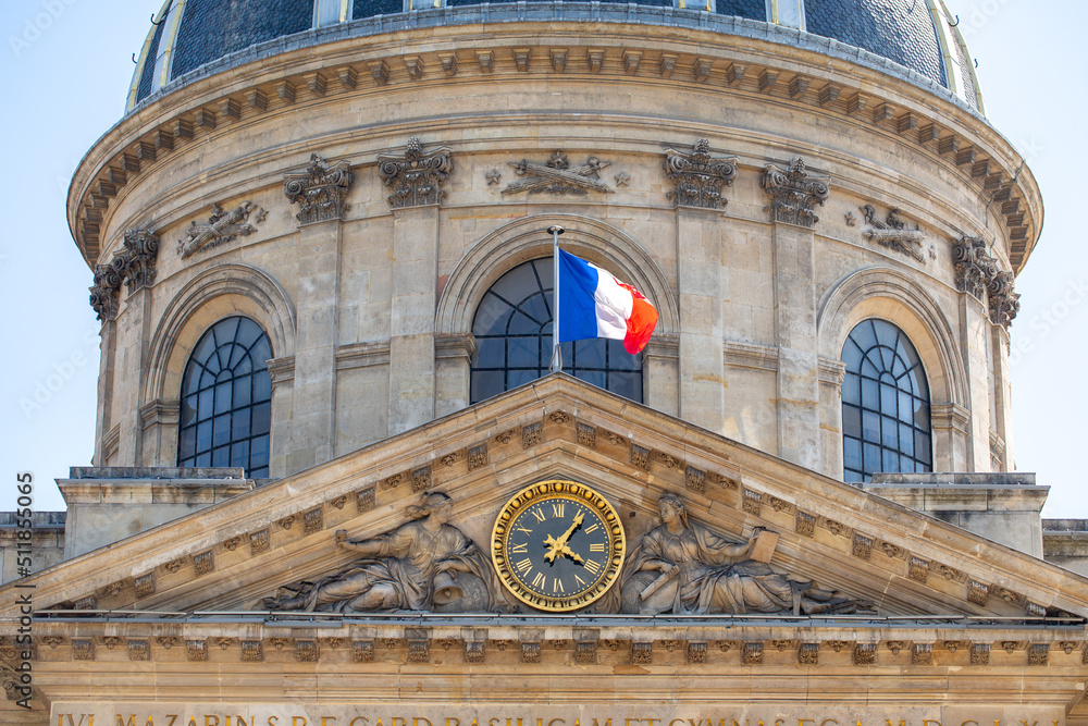 Building in France with the flag of France. French flag on the building. France helps Ukraine. French flag. Clock architecture. Administrative building.