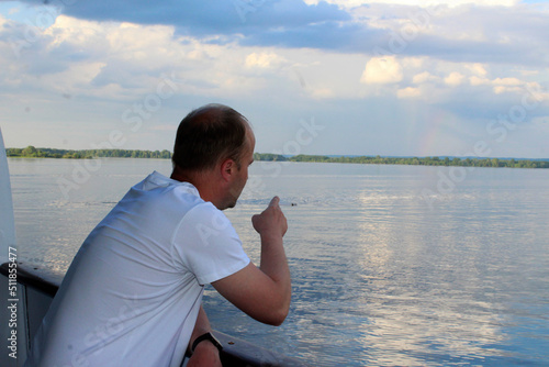 Wallpaper Mural a man with a cigarette in his hand stands on the deck of a ship and points to a rainbow in the sky Torontodigital.ca
