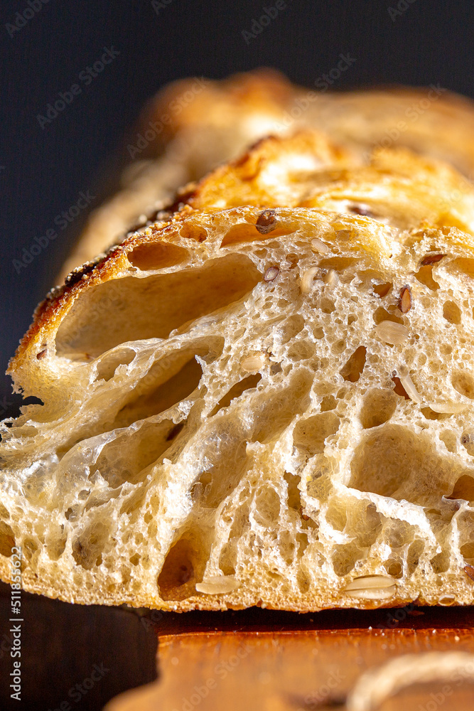 Bread macro. Bread pores. Fresh baguette with grains macro.Bakery advertisement. Seeds in bread. Freshly baked bread. French baguette cut. Fresh bakery. Bun in a cut. Baking from the oven. Bakery Bread macro. Bread pores. Fresh baguette with grains macro.Bakery advertisement. Seeds in bread. Freshly baked bread. French baguette cut. Fresh bakery. Bun in a cut. Baking from the oven. Bakery