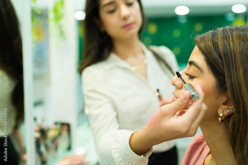 Young woman buying mascara at the makeup shop Young woman buying mascara at the makeup shop