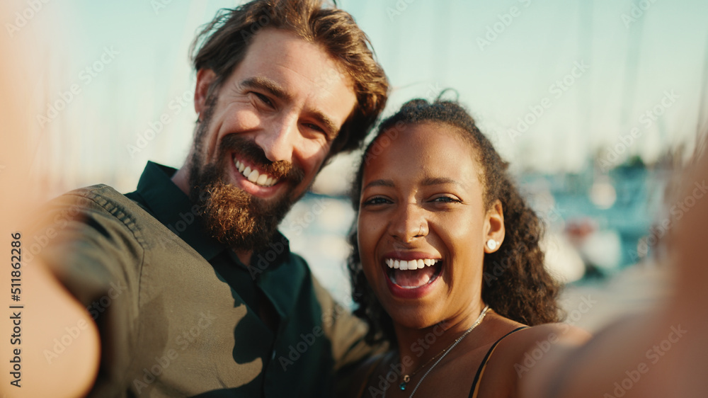 Close up portrait of happy man and smiling woman doing stream on smartphone. Close-up, joyful young interracial couple communicating via video call using mobile phone Close up portrait of happy man and smiling woman doing stream on smartphone. Close-up, joyful young interracial couple communicating via video call using mobile phone