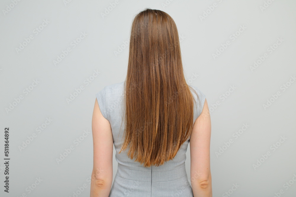 Woman in business dress standing back, female portrait with long hair. Back view. Rear view. Woman in business dress standing back, female portrait with long hair. Back view. Rear view.