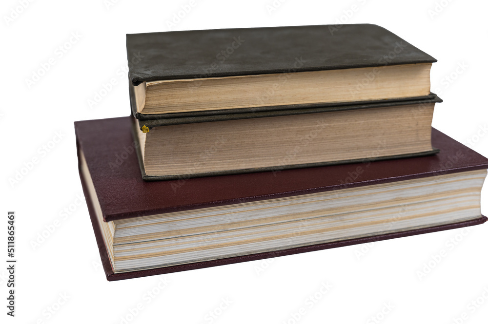 A stack of books isolated against a white background. Large red book and two green ones. Closed books with yellowed pages. Hardcover. Literature, reading, knowledge. Close-up. Selective Focus. A stack of books isolated against a white background. Large red book and two green ones. Closed books with yellowed pages. Hardcover. Literature, reading, knowledge. Close-up. Selective Focus.