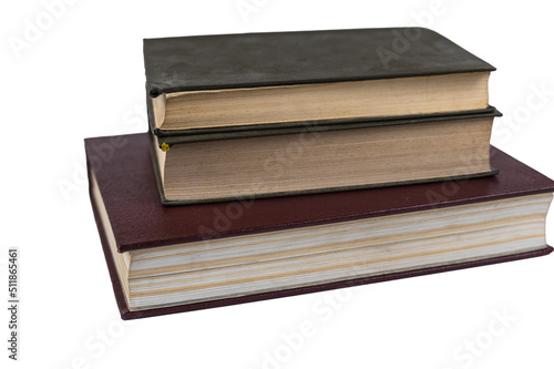A stack of books isolated against a white background. Large red book and two green ones. Closed books with yellowed pages. Hardcover. Literature, reading, knowledge. Close-up. Selective Focus.