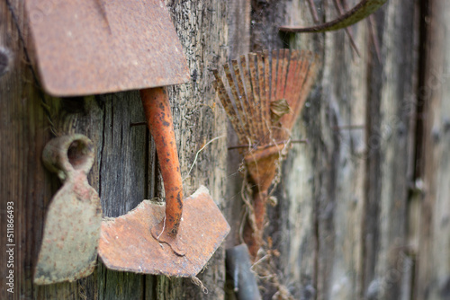Old gardening tools hanging on the barn wall