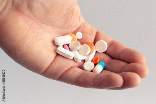 Close Up of hand holding colorful pills. Medicine and health care concept. Healthy lifestyle, medicine, nutritional supplements and people concept