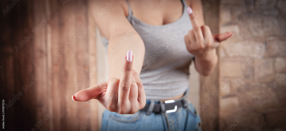 Young caucasian woman showing middle finger.