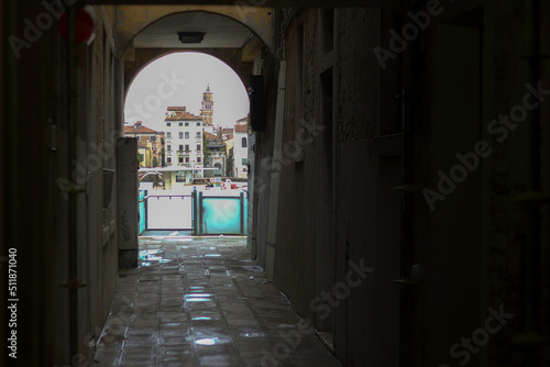Venice, Italy - View through a tunnel making it look like a frame with buildings visible against river