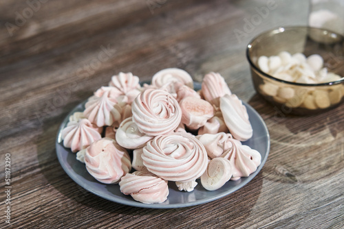 beautiful pink meringues on a plate close-up for cake decoration