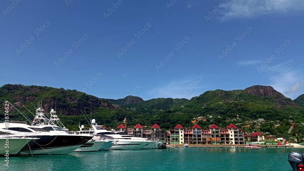 Panorama of the sea with expensive yachts and mountains covered with lots of greenery