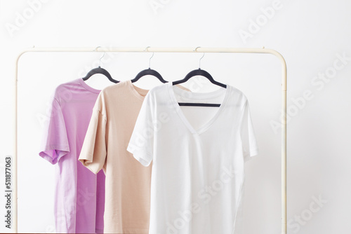 women's t-shirts on hanger on white background