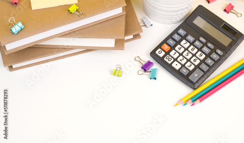 Back to school flatlay with books,calculator,pencils and other supplies on white bacground. Banner with place for text photo