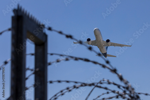 aviation, travel by airplane, airport, Franz Josef Strauss, Munich, Bavaria, Germany, Mai 2022, airplane flying over the barbed wire fence