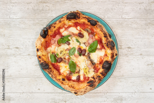 Italian handmade fresh pizza on wooden table high angle view