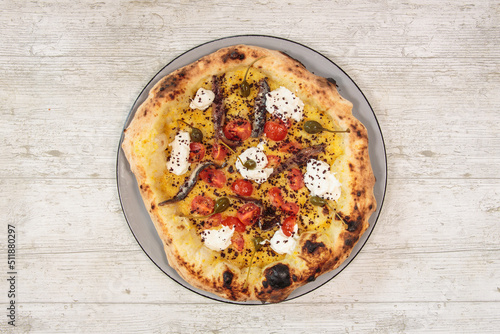 Italian handmade fresh pizza on wooden table high angle view