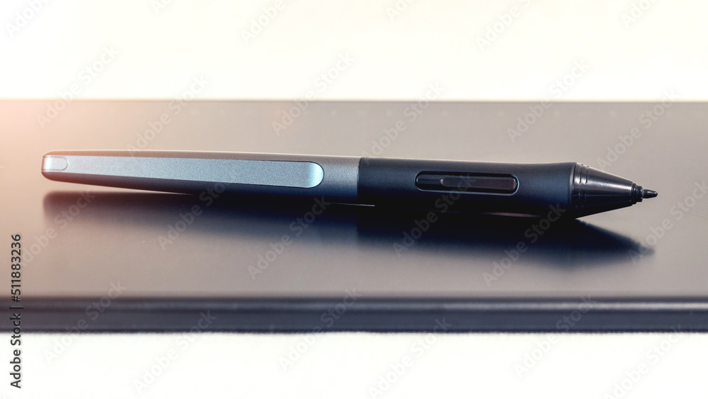 Graphic tablet and pen, stylus, with stand on a light background Graphic tablet and pen, stylus, with stand on a light background