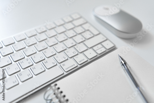 Office table desk. Workspace with sketchpad, keyboard, office supplies, pencil, on white table.