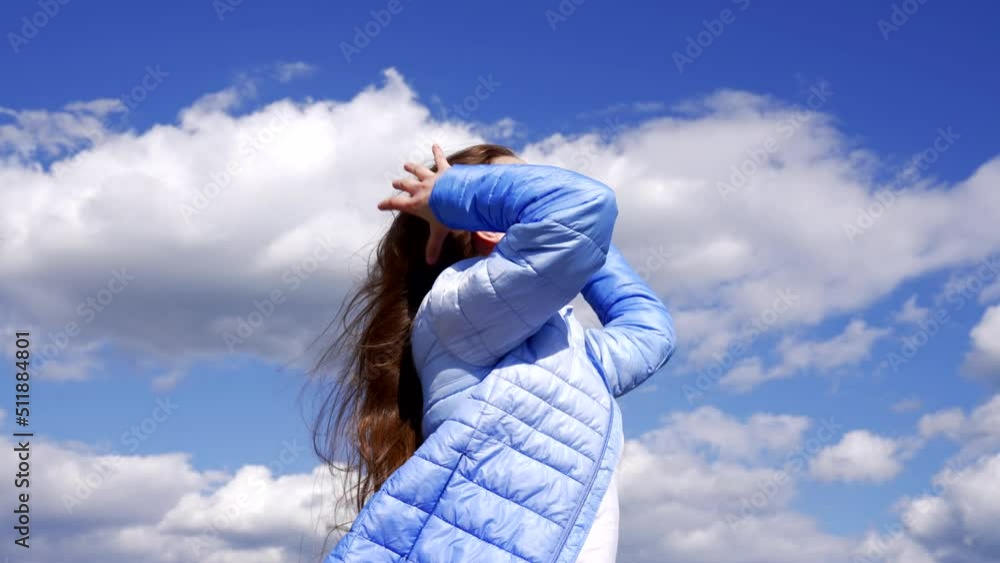 happy child in autumn jacket enjoy long windy hair on sky background, hairdo happy child in autumn jacket enjoy long windy hair on sky background, hairdo