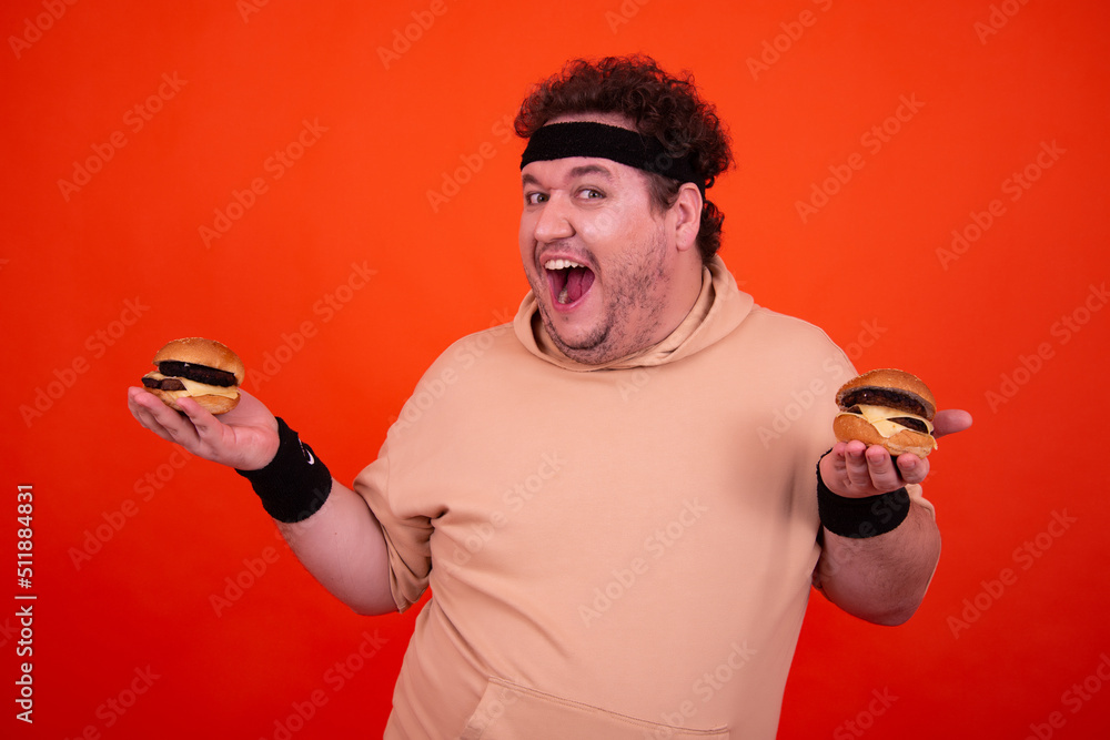 Diet and fast food. Funny fat man eats a hamburger. Stock Photo | Adobe ...