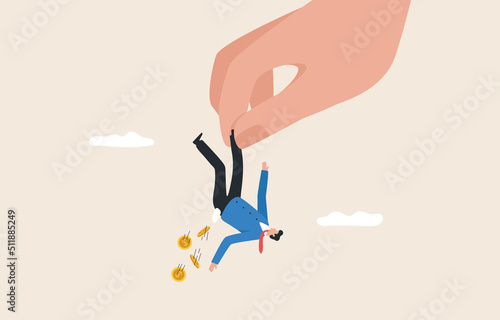 Breaking out of business or investment. Businessman with financial problems. Giant hand holding a businessman hanging upside down.