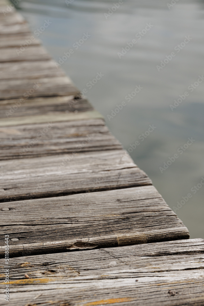 close-up of old wooden planks of a pier over lake water close-up of old wooden planks of a pier over lake water