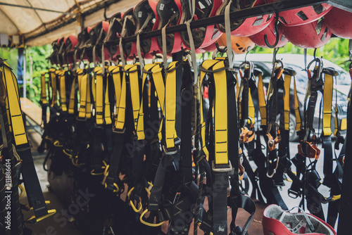 Rows of climbing safety ropes and carabiners and helmets