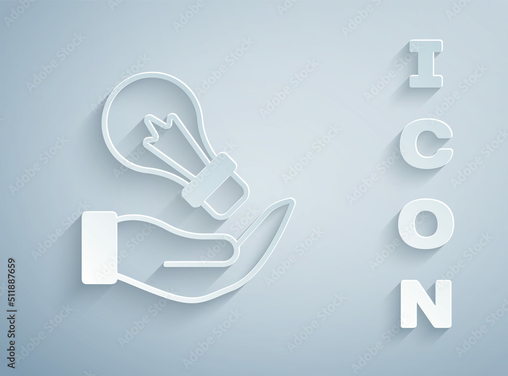 Paper cut Light bulb in hand with concept of idea icon isolated on grey background. Energy and idea symbol. Inspiration concept. Paper art style. Vector Paper cut Light bulb in hand with concept of idea icon isolated on grey background. Energy and idea symbol. Inspiration concept. Paper art style. Vector
