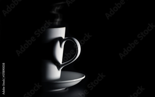 White coffee cup with shadow from handle in heart form, isolated on black background