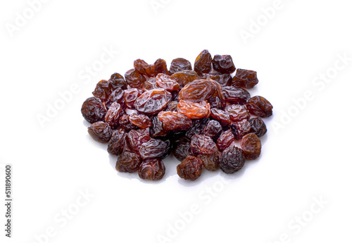 Dried raisins in spoon on white background.