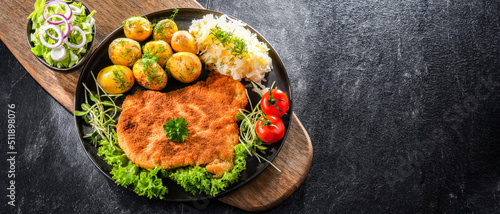 Print op canvas Pork cutlet coated with breadcrumbs with potatoes and cabbage