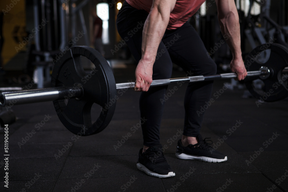 Cropped shot of a sportsman lifting heavy barbell