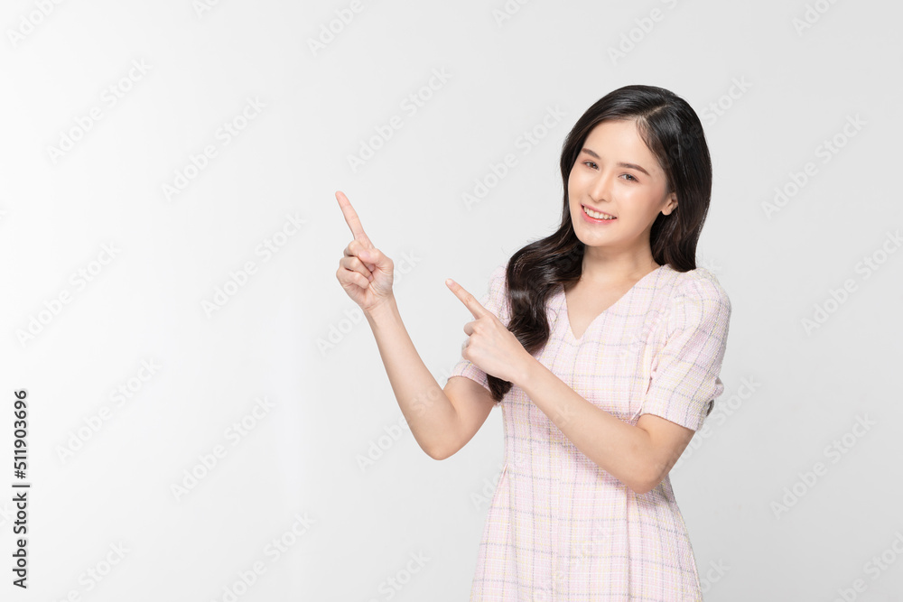 Happy attractive asian young woman smile and pointing to copy space isolated on white background. Cheerful pretty girl wear casual dress pointing finger to empty space for mockup to display product Happy attractive asian young woman smile and pointing to copy space isolated on white background. Cheerful pretty girl wear casual dress pointing finger to empty space for mockup to display product