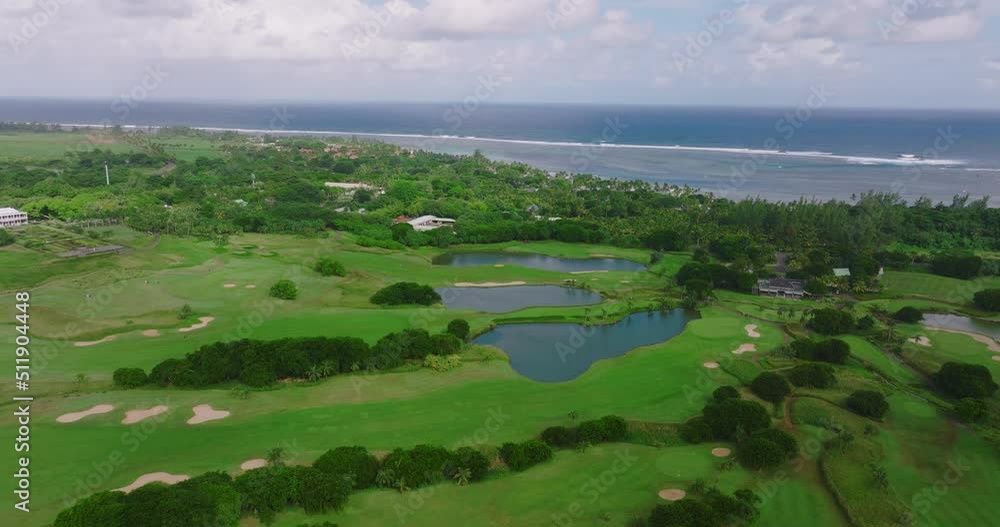 Aerial view of Golf Course with putting green grass and trees. Amazing bird eye view over Golf courses in summer sunny day. Green course and villas on the beach Aerial view of Golf Course with putting green grass and trees. Amazing bird eye view over Golf courses in summer sunny day. Green course and villas on the beach