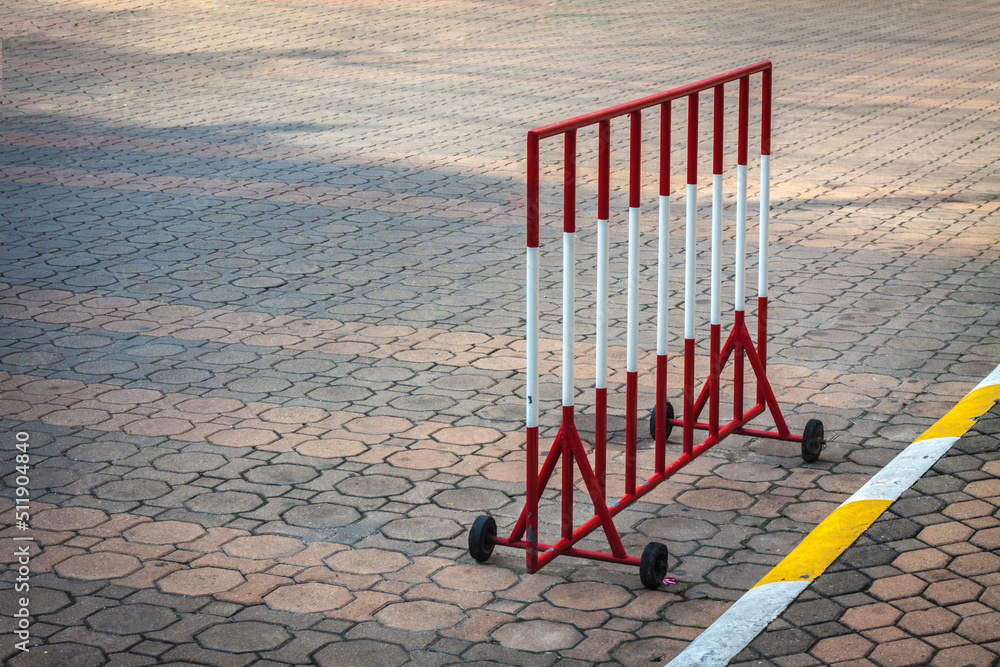 Outdoor parking barricades and yellow-white concrete sidewalk curb with traffic. yellow and white road security barrier isolated. the road with striped road barrier