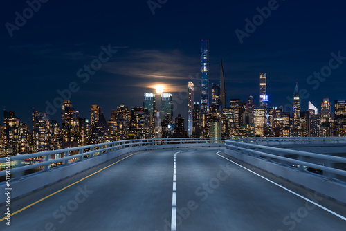 Empty urban asphalt road exterior with city buildings background. New modern highway concrete construction. Concept of way to success. Transportation logistic industry fast delivery. New York. USA.