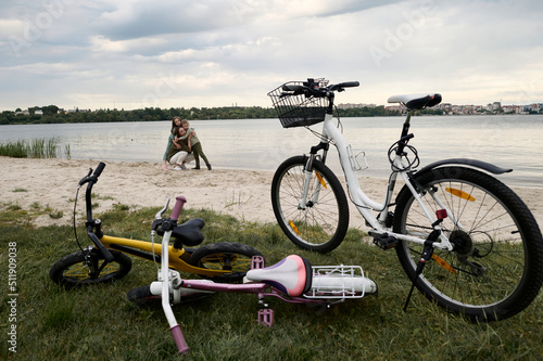 A cute family with a bicycles on a river band