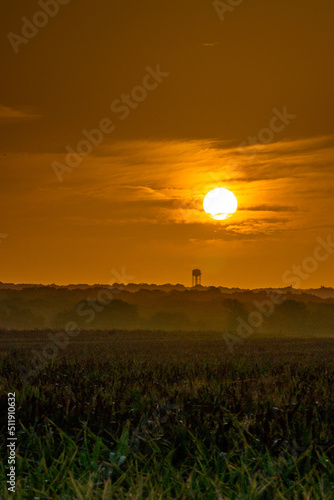 Texas Sunset with clouds  water tower and farmland