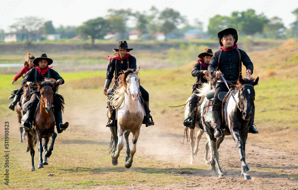 Group of cowboy and cowgirl ride horse on road with high speed near water reservoir with day light. Group of cowboy and cowgirl ride horse on road with high speed near water reservoir with day light.